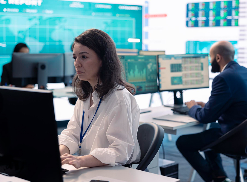 Woman monitoring data in a modern cyber security operations center, ideal for a Cyber Security Track.